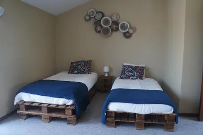 two beds in a room with plates on the wall at Casa no centro histórico in Vila Nova de Gaia