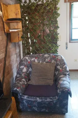 a couch with a pillow on it in a room at Casa no centro histórico in Vila Nova de Gaia