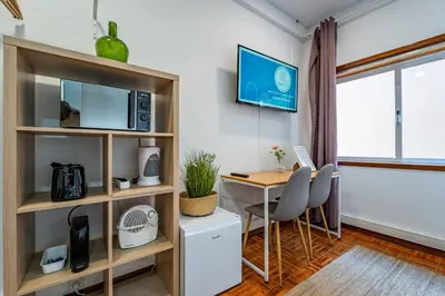 a room with a desk and a table with chairs at Oporto Center at Your Doorstep 1 in Porto
