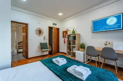 a bedroom with a bed with two towels on it at Oporto Center at Your Doorstep 1 in Porto