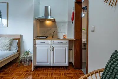 a kitchen with white cabinets and a sink in a room at Oporto Center at Your Doorstep 1 in Porto