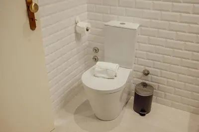 a bathroom with a toilet with a towel on it at Bright Deluxe by Hosty in Porto