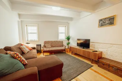 a living room with a couch and a flat screen tv at Historical Duplex by Hosty in Porto