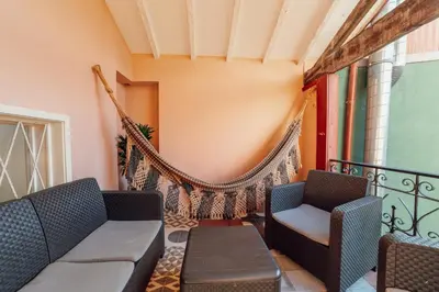 a balcony with two chairs and a hammock at Historical Duplex by Hosty in Porto