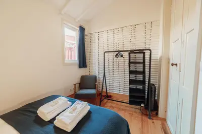 a bedroom with a bed with two towels on it at Historical Duplex by Hosty in Porto