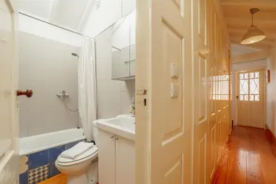 a bathroom with a white toilet and a sink at Historical Duplex by Hosty in Porto