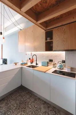 a kitchen with white cabinets and a sink at Batalha Charming Loft in Porto