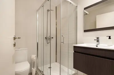 a bathroom with a shower and a toilet and a sink at Mezzanine Studio in the City Center in Porto