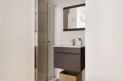 a bathroom with a sink and a mirror at Mezzanine Studio in the City Center in Porto