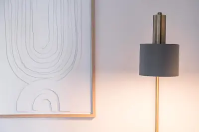 a black lamp next to a picture on a wall at GuestReady - Welcoming place in Porto in Porto