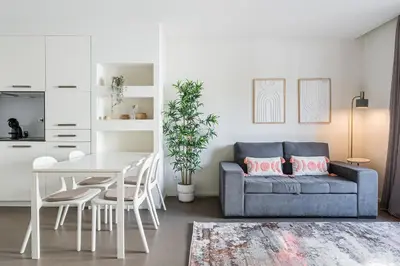 a living room with a blue couch and a table at GuestReady - Welcoming place in Porto in Porto