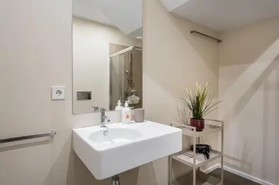 a white bathroom with a sink and a mirror at GuestReady - Welcoming place in Porto in Porto