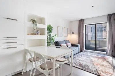 a white dining room with a white table and chairs at GuestReady - Welcoming place in Porto in Porto
