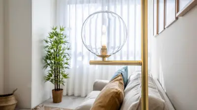 a living room with a couch and a globe lamp at TrindadeFlat w AC by LovelyStay in Porto