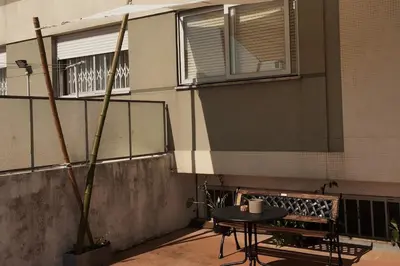 a table and a bench in front of a building at Porto's secret backyard in Porto