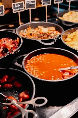 a bunch of pans of food on a table at The Log Porto Hotel by Piamonte Hotels in Porto