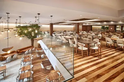 a restaurant with wooden floors and tables and chairs at The Log Porto Hotel by Piamonte Hotels in Porto