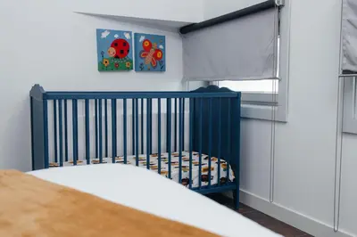 a blue crib in a bedroom with a window at Ark of Aqua Flat in Porto
