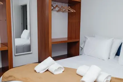 a room with two beds and a mirror at Ark of Aqua Flat in Porto