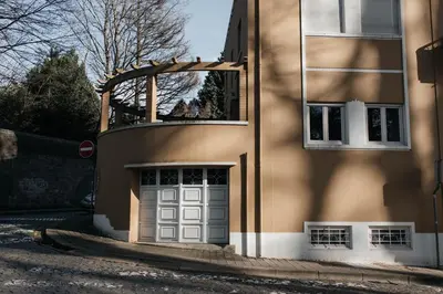 a building with a garage door on a street at Ark of Aqua Flat in Porto