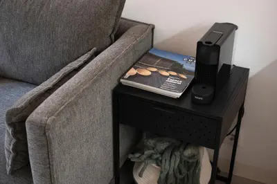 a phone on a table next to a couch at St Ildefonso 02 in Porto