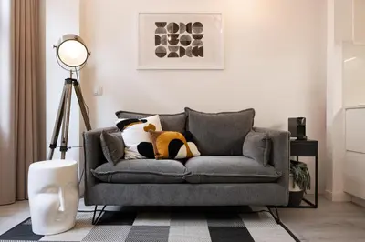 a living room with a gray couch with stuffed animals on it at St Ildefonso 02 in Porto