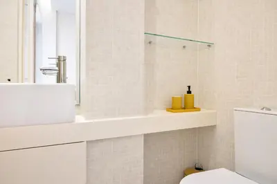 a bathroom with a toilet and a sink and a shower at St Ildefonso 03 in Porto