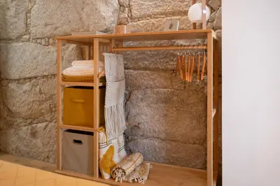 a shelf in a room with a stone wall at St Ildefonso 04 in Porto