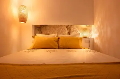 a bedroom with a large bed with yellow pillows at St Ildefonso 04 in Porto