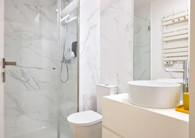 a white bathroom with a toilet and a sink at St Ildefonso 04 in Porto