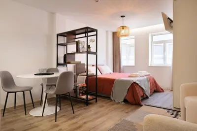 a bedroom with a bed and a desk and a table at St Ildefonso 05 in Porto