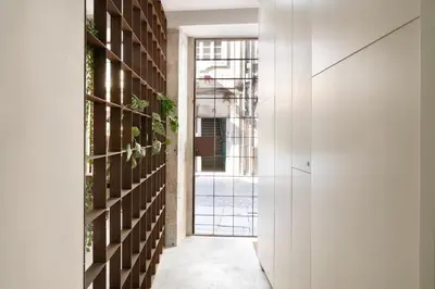 a hallway with a door leading into a building at St Ildefonso 05 in Porto