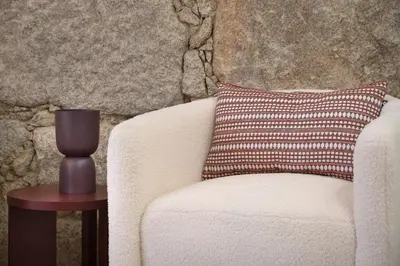a pillow on a chair next to a table at St Ildefonso 05 in Porto