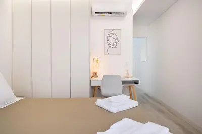 a small bedroom with a bed and a desk at St Ildefonso 06 in Porto