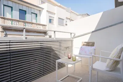 a balcony with two chairs and a table at St Ildefonso 06 in Porto