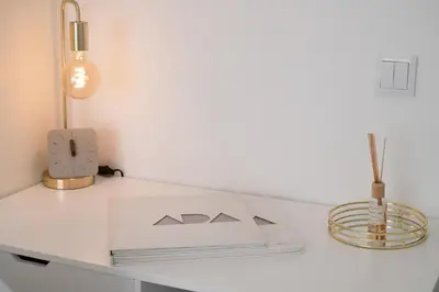 a white desk with a lamp and a book on it at St Ildefonso 06 in Porto