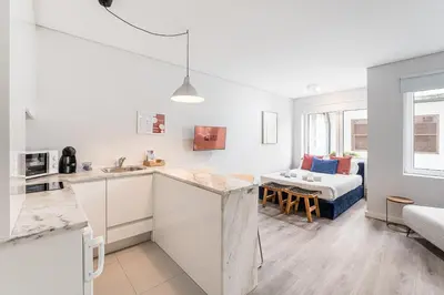 a kitchen and a living room with a couch at GuestReady - Homely stay in Porto in Porto