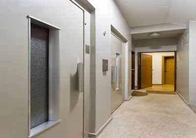 a hallway of a building with doors and windows at Trindade 99 - Porto Downtown Apartment in Porto