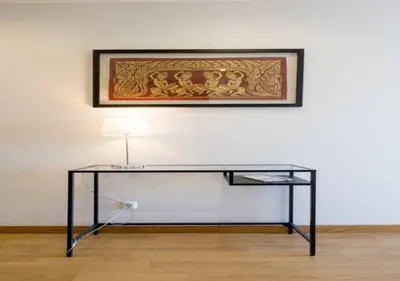 a black table with a lamp on a white wall at Trindade 99 - Porto Downtown Apartment in Porto