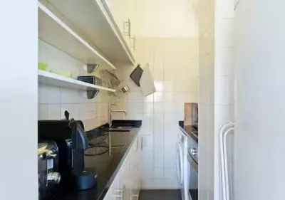 a small kitchen with a sink and a stove at Trindade 99 - Porto Downtown Apartment in Porto