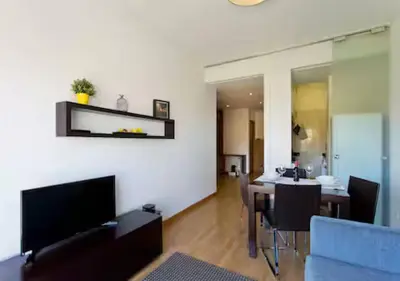 a living room with a table and a blue couch at Trindade 99 - Porto Downtown Apartment in Porto