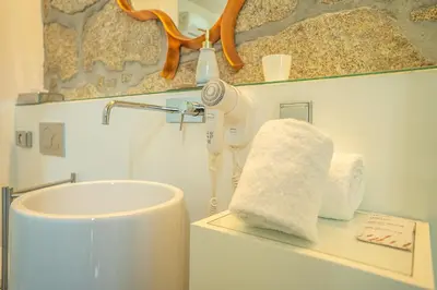 a bathroom with a blow dryer and a towel at CHARM by YoursPorto in Vila Nova de Gaia