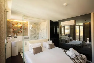 a hotel room with two beds and a mirror at CHARM by YoursPorto in Vila Nova de Gaia