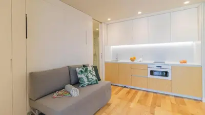 a living room with a couch and a kitchen at 3T Charming apartment in Boavista in Porto
