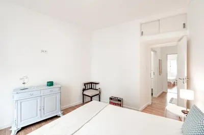 a white bedroom with a bed and a dresser at ViVA Bright & Spacious Gaia in Vila Nova de Gaia
