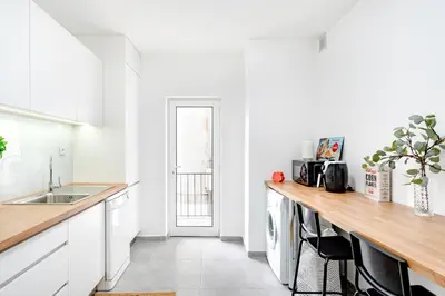a white kitchen with a counter and a sink at ViVA Bright & Spacious Gaia in Vila Nova de Gaia