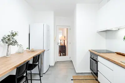 a kitchen with white walls and a wooden counter top at ViVA Bright & Spacious Gaia in Vila Nova de Gaia