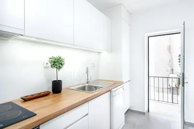 a kitchen with white cabinets and a sink at ViVA Bright & Spacious Gaia in Vila Nova de Gaia