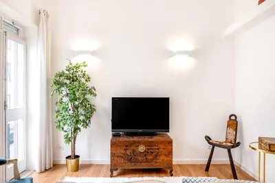 a living room with a flat screen tv on a wooden chest at ViVA Bright & Spacious Gaia in Vila Nova de Gaia