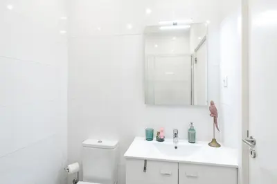 a white bathroom with a sink and a toilet at ViVA Bright & Spacious Gaia in Vila Nova de Gaia